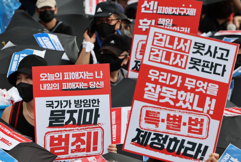 [서울=뉴시스] 황준선 기자 = 18일 오후 서울 종로구 금융위원회가 위치한 정부서울청사 앞에서 티메프 사태 피해자 단체원들이 '모두가 예비 피해자, 특별법 제정 요구합니다' 검은우산 집회를 하고 있다. 2024.08.18. hwang@newsis.com