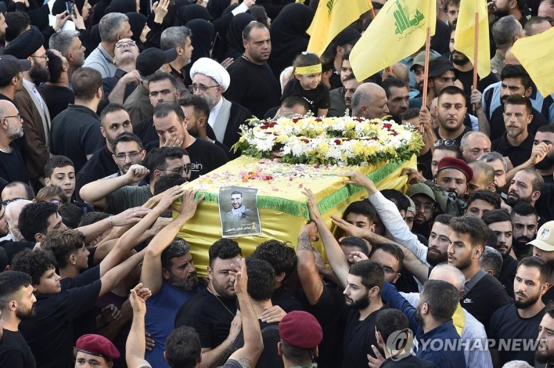 "이스라엘 삐삐·무전기 폭탄은 '부비트랩 전쟁범죄'" 베이루트서 거행된 '삐삐 폭발' 사망자 장례식 (베이루트 EPA=연합뉴스) 18일(현지시간) 레바논 수도 베이루트 남부 지역에서 전날 발생한 무선호출기(삐삐) 동시다발 폭발 사건 사망자의 장례식에 참석한 문상객들이 관을 옮기고 있다. 레바논 당국은 이번 '삐삐 폭발' 사건으로 최소 12명이 숨지고 2천800명 이상이 다쳤다고 밝혔다. 2024.09.19 passion@yna.co.kr (끝)