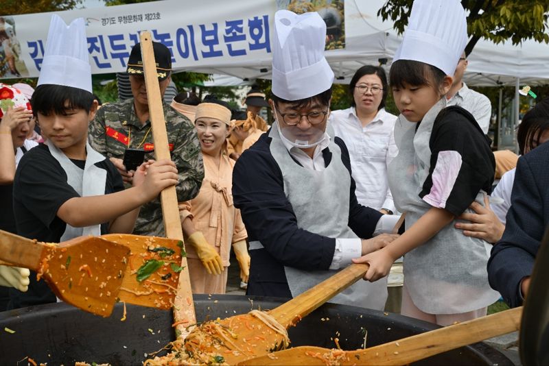 김포통진두레놀이보존회에서 김포쌀을 이용해 가마솥에 밥을 짓는 '전통 가마솥 밥짓기 대회'에 참여한 김병수 김포시장과 시민들. /김포시 제공