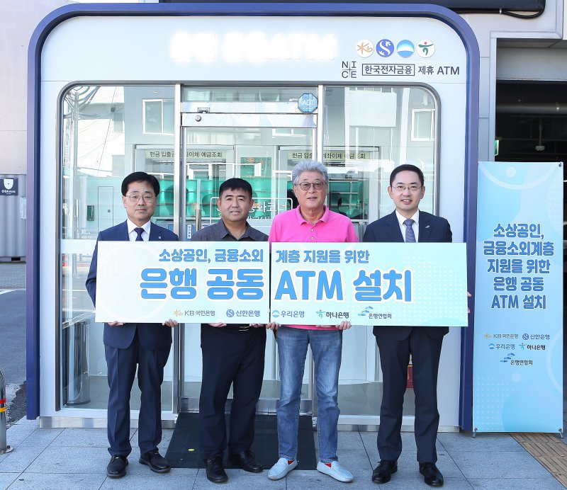 지난달 30일 강원도 삼척중앙시장에서 열린 은행 공 ATM 설치 행사에서 박규상 한국전자금융 전무이사(왼쪽 첫 번째), 김종한 삼척시청 경제과장(왼쪽 두 번째), 정종광 삼척중앙시장 상인회장(왼쪽 세 번째), 이인균 은행연합회 본부장이 기념촬영을 하고 있다. 은행연합회 제공