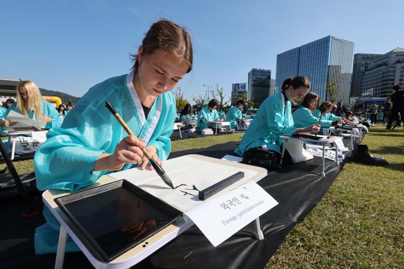 제578돌 한글날을 맞은 9일 서울 종로구 광화문광장에서 한국예술문화원 주체로 열린 조선시대 과거 시험 재현 ‘휘호대회’에서 참가자들이 글씨를 적고 있다. 사진=박범준 기자