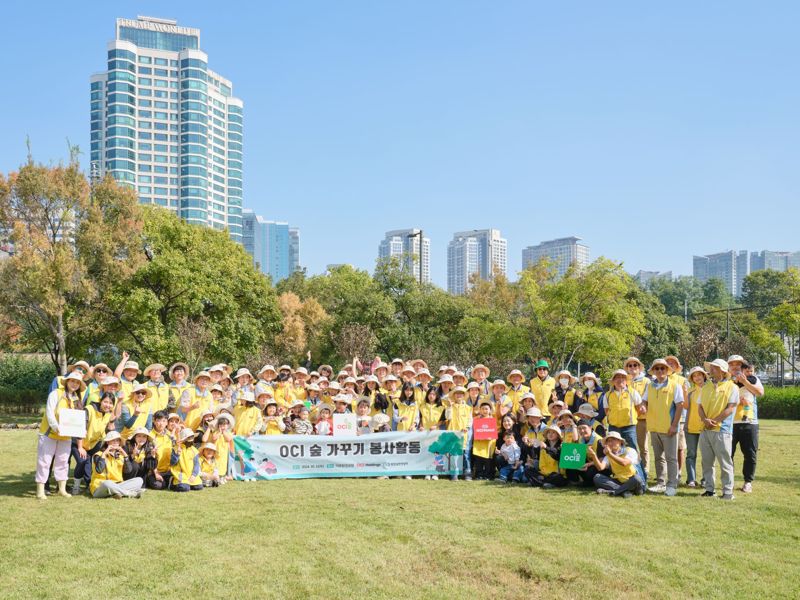 지난 12일 서울 이촌한강공원에서 OCI그룹 임직원들이 OCI 숲 가꾸기 행사 이후 기념촬영을 하고 있다. OCI홀딩스제공