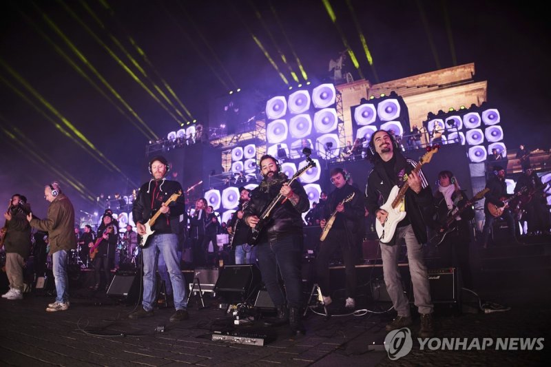 베를린 장벽 붕괴 35주년 기념 콘서트에서 협연 중인 음악가들 To mark the fall of the Berlin Wall 35 years ago in Germany's capital, a concert with hundreds of musicians will take place in front of the Brandenburg Gate, Saturday, Nov. 9, 2024, in Berlin. (Joerg Carstensen/dpa via AP) GERMANY OUT; MANDATORY CREDIT