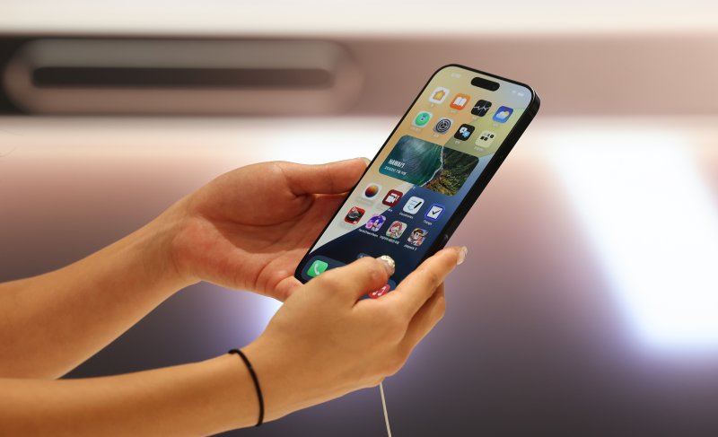 [서울=뉴시스] 김근수 기자 = 20일 서울 마포구 머큐리 앰버서더 호텔 홍대 T팩토리에서 한 직원이 아이폰16 제품을 들어보이고 있다. 2024.09.20. ks@newsis.com