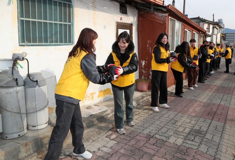 한국관광광공사 임직원들이 13일 강원도 원주 봉산동 주민을 위한 연탄 나눔 봉사활동을 펼치고 있다. 한국관광공사 제공