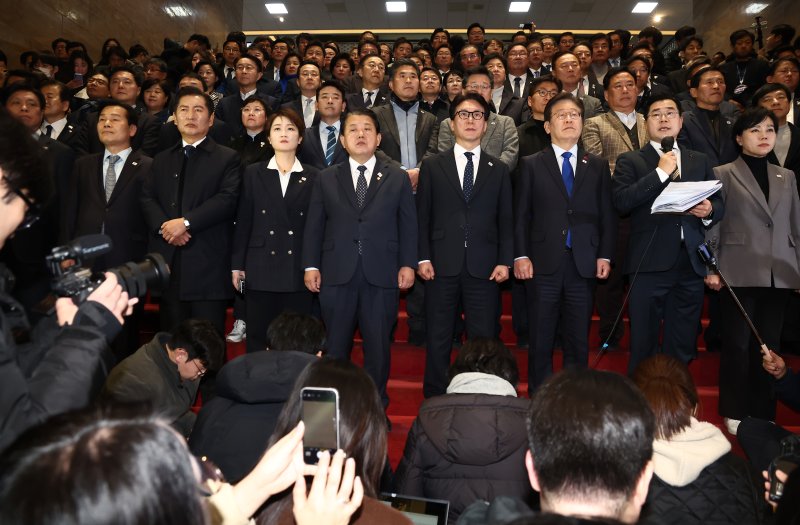 윤석열 대통령의 탄핵안이 국회 본회의를 통과한 14일 오후 서울 여의도 국회 로텐더홀 앞에서 더불어민주당 이재명 대표를 비롯한 의원들이 입장을 밝히고 있다. 2024.12.14/뉴스1 ⓒ News1 김민지 기자