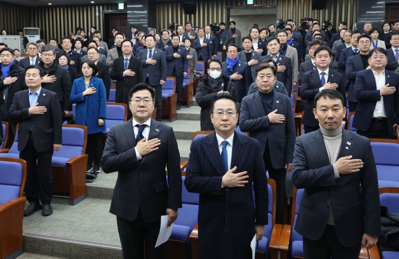 박찬대 더불어민주당 원내대표를 비롯한 의원들이 16일 오후 서울 여의도 국회에서 열린 의원총회에서 국민의례를 하고 있다. 뉴시스