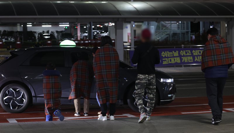 [부산=뉴시스] 하경민 기자 = 부산 강서구 김해국제공항 계류장에 있던 홍콩행 에어부산 BX391편 항공기(기종 A321) 후미에서 원인이 밝혀지지 않은 불이 나 승객 170명과 승무원 6명 등 총 176명이 긴급 대피했으며, 이 과정에서 3명이 경상을 입고 인근 병원으로 이송됐다. 사진은 29일 새벽 화재 항공기 승객들이 이동하는 모습. 2025.01.29. yulnetphoto@newsis.com