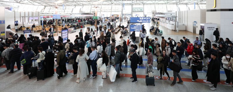설 연휴를 하루 앞둔 지난 1월 24일 인천국제공항 출국장에서 여행객들이 항공기 탑승 수속을 밟기 위해 줄을 서고 있다. 뉴시스