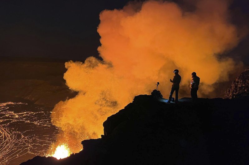[하와이=AP/뉴시스] 미국지질조사국(USGS)이 제공한 사진에 11일(현지 시간) 하와이주 하와이 화산국립공원 킬라우에아 화산 정상에서 USGS 지질학자들이 할레마우마우 분화구에서 분출되는 용암을 살펴보고 있다. 2025.02.13.