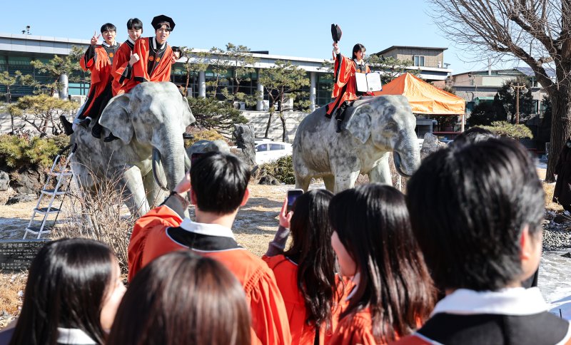 13일 서울 중구 장충동 동국대학교에서 열린 '2025년 봄 학위수여식'에서 졸업생들이 코끼리 동상에 올라타 기념촬영을 하고 있다. 2025.2.13/뉴스1 ⓒ News1 김도우 기자