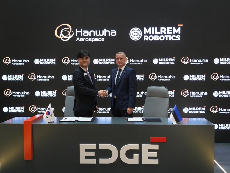 지난 18일 UAE 아부다비에서 진행 중인 'IDEX 2025' 전시회에서 김동현 한화에어로스페이스 LS사업부장(왼쪽)과 쿨다 바라시(Kuldar Väärsi) 밀렘 로보틱스 CEO(오른쪽)가 양사 간 UGV 공동개발 및 전략적 파트너십을 확대하는 양해각서(MOU)를 체결하고 기념사진을 찍고 있다. (한화에어로스페이스 제공)