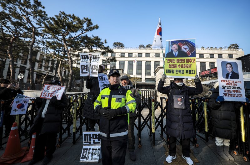 [서울=뉴시스] 정병혁 기자 = 윤석열 대통령의 탄핵심판 최종 변론기일을 앞둔 25일 서울 종로구 헌법재판소에서 윤 대통령 탄핵 찬성, 반대 피켓을 든 시민이 1인 시위를 하고 있다. 2025.02.25. jhope@newsis.com