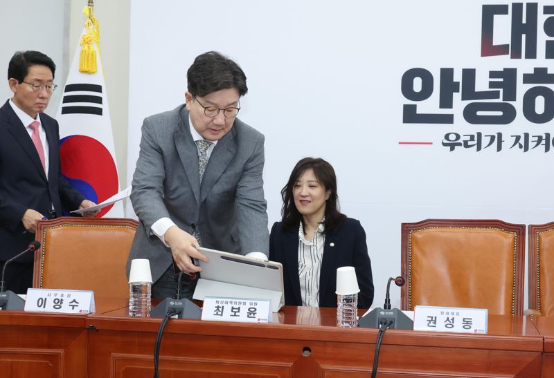 권성동 국민의힘 원내대표가 6일 국회에서 열린 비상대책위원회의에서 최보윤 위원의 태블릿PC를 회의실에 놓아주고 있다. 사진=박범준 기자