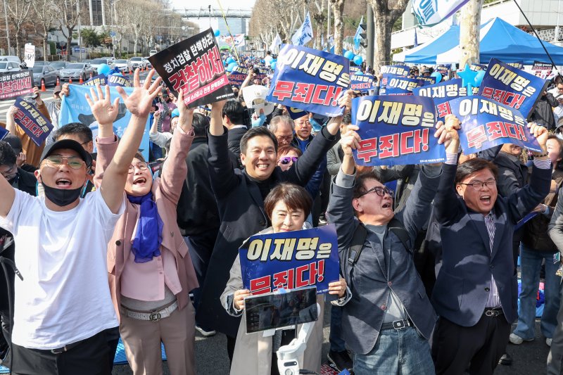 이재명 더불어민주당 대표의 공직선거법 위반 사건 2심 선고일인 26일 오후 서울 서초구 서울중앙지방검찰청 앞에서 이재명 대표 지지자들이 이 대표의 무죄 판결 소식에 기뻐하고 있다. 2025.3.26/뉴스1 ⓒ News1 민경석 기자