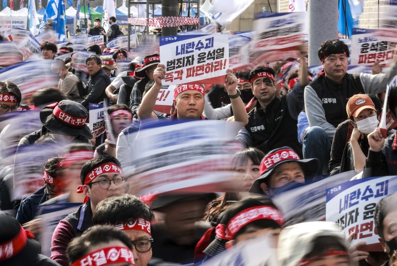 [서울=뉴시스] 정병혁 기자 = 26일 서울 종로구 동십자각 앞에서 열린 윤석열 즉각 파면을 위한 한국노총 전국단위노조대표자 및 상근간부 결의대회에서 한국노총 조합원들이 피켓을 들고 있다. 2025.03.26. jhope@newsis.com