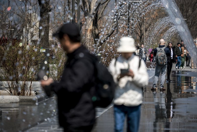[서울=뉴시스] 정병혁 기자 = 광화문광장 분수가 가동을 시작한 가운데 1일 외국인 여행객들이 분수를 배경으로 사진을 찍고 있다. 2025.04.01. jhope@newsis.com