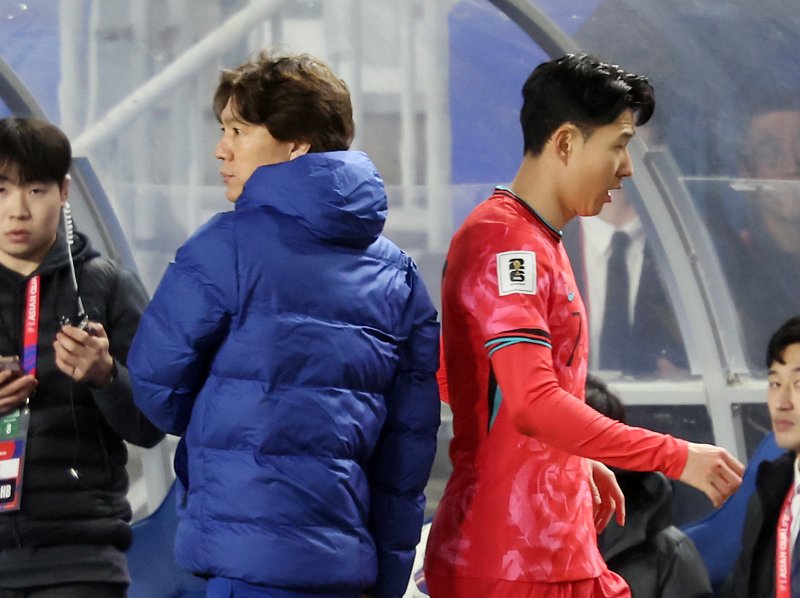 [수원=뉴시스] 김명년 기자 = 25일 경기 수원시 수원월드컵경기장에서 열린 2026 국제축구연맹(FIFA) 북중미 월드컵 아시아 지역 3차 예선 B조 8차전 대한민국과 요르단의 경기, 교체아웃된 손흥민이 홍명보 감독과 인사를 하고 있다. 2025.03.25. kmn@newsis.com