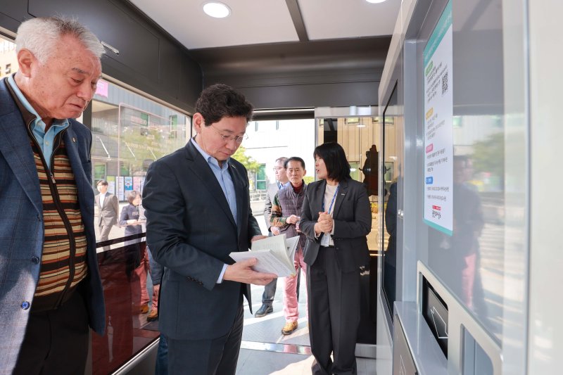 이상일 시장이 마북동행정복지센터에 설치된 스마트도서관에서 책을 대출하고 있는 모습.(용인시 제공)