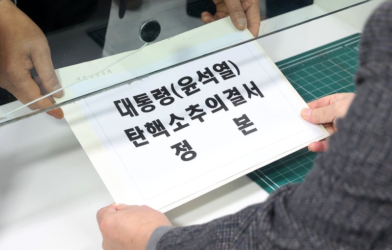 [서울=뉴시스] 홍효식 기자 = 윤석열 대통령에 대한 탄핵소추안 재표결이 가결된 14일 오후 서울 종로구 헌법재판소 민원실에서 정청래 국회 법제사법위원장이 윤석열 대통령 탄핵소추의결서를 제출하고 있다. 2024.12.14. yesphoto@newsis.com