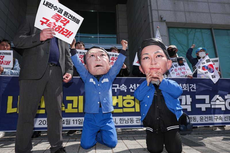 촛불행동 회원들이 11일 서울 용산구 한남동 대통령 관저 앞에서 열린 윤건희 구속 선봉대 발족 기자회견에서 윤석열 전 대통령과 김건희 여사의 모형탈을 쓰고 체포 상징의식을 하고 있다. 2025.4.11/뉴스1 ⓒ News1 김성진 기자