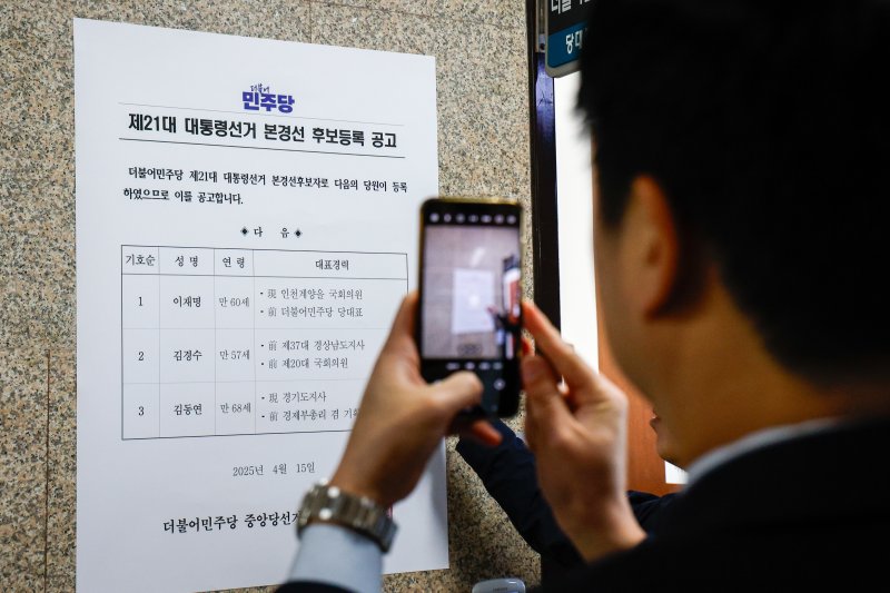16일 서울 여의도 국회 더불어민주당 대표실 앞에서 관계자가 이재명 전 대표, 김경수 전 경남지사, 김동연 경기지사 제21대 대통령선거 본경선 후보등록 공고문을 부착하고 있다. 2025.4.16/뉴스1 ⓒ News1 안은나 기자