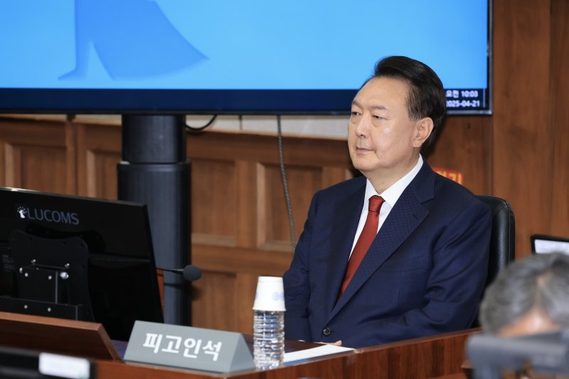 [서울=뉴시스] 사진공동취재단 = 12·3 비상계엄을 선포해 내란 우두머리 혐의로 재판에 넘겨진 윤석열 전 대통령이 21일 오전 서울 서초구 서울중앙지법 417호 법정에 앉아 재판 시작을 기다리고 있다. 2025.04.21. photo@newsis.com