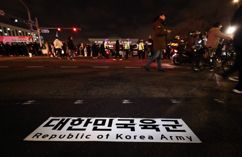 윤석열 대통령이 비상계엄령을 선포한 가운데 4일 새벽 서울 여의도 국회 앞에 육군 버스에 붙어 있는 현판이 떨어져 있다. 2024.12.4/뉴스1 ⓒ News1 구윤성 기자