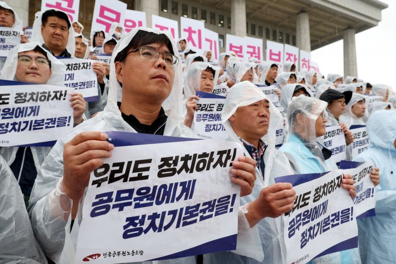 [서울=뉴시스] 조성봉 기자 = 22일 오전 서울 여의도 국회 본청 계단에서 열린 전국공무원노동조합 대선요구안 발표 기자회견에서 참가자들이 '정치기본권 보장'을 요구하는 손피켓을 들고 있다. 2025.04.22. suncho21@newsis.com