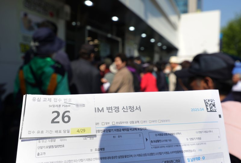 [서울=뉴시스] 홍효식 기자 = SK텔레콤이 유심 고객정보 해킹 사고와 관련해 유심 무상 교체를 진행하는 가운데 29일 오전 서울 시내 한 T월드 매장 앞에서 한 고객이 유심 교체 접수 번호를 들고 대기하고 있다. 2025.04.29. yesphoto@newsis.com
