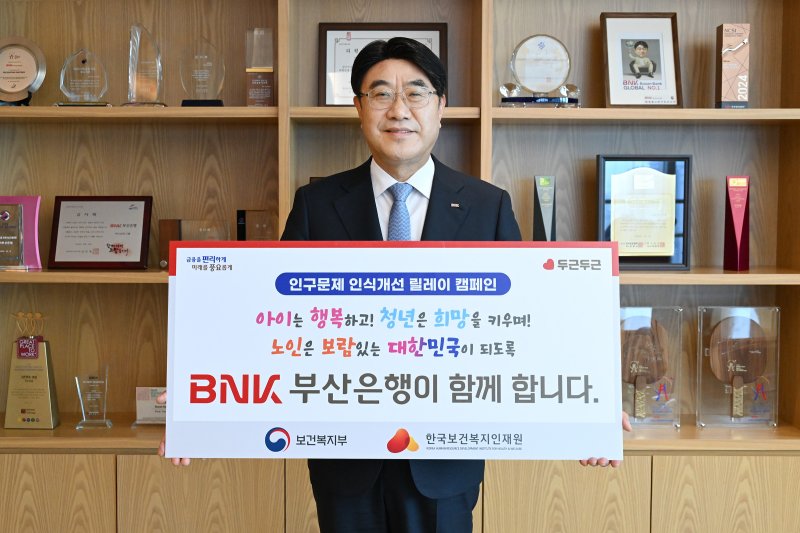 방성빈 부산은행장이 30일 '인구문제 인식개선 릴레이 캠페인' 참여 피켓을 들고 포즈를 취하고 있다. 부산은행 제공