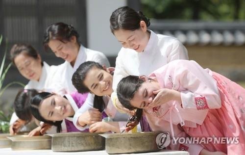 단오 맞아 창포물에 머리 감는 외국인 유학생 (출처=연합뉴스)