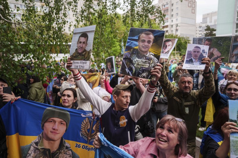 [우크라이나=AP/뉴시스] 6일(현지 시간) 우크라이나의 장소 미공개 지역에서 러시아와의 포로 교환을 통해 석방된 우크라이나 군인들에게 실종되거나 억류 중인 군인 가족들이 사진을 보여주며 생사를 확인하고 있다. 2025.05.07.