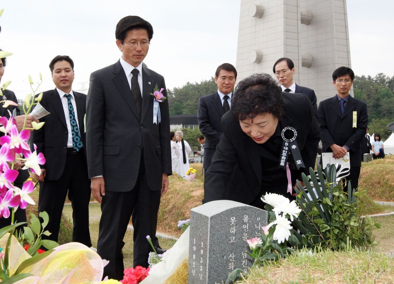 김문수 경기도지사가 18일 광주 국립 5.18민주묘지에서 열린 '제28주년 5.18민주화운동 기념식'참석해 박관현열사의 묘지를 찾아 박관열열사의 누님인 박행순여사와 묘비를 둘러보고 있다. (사진=경기도 제공) 뉴시스
