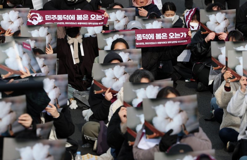 [서울=뉴시스] 이영환 기자 = 동덕여대재학생연합 소속 학생 등이 3일 오후 서울 종로구 북인사마당 인근에서 진행된 동덕여대 재단 규탄 집회에서 교화인 목화 피켓을 들고 구호를 외치고 있다. 2025.03.03. 20hwan@newsis.com