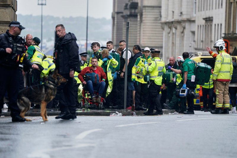 [리버풀=AP/뉴시스] 26일(현지 시간) 영국 리버풀 워터 스트리트에서 열린 리버풀FC의 프리미어리그(EPL) 우승 축하 퍼레이드 현장에서 군중들 사이로 차량이 돌진하는 사고가 발생해 소방대원과 경찰이 부상자를 이송하고 있다. 2025.05.27.