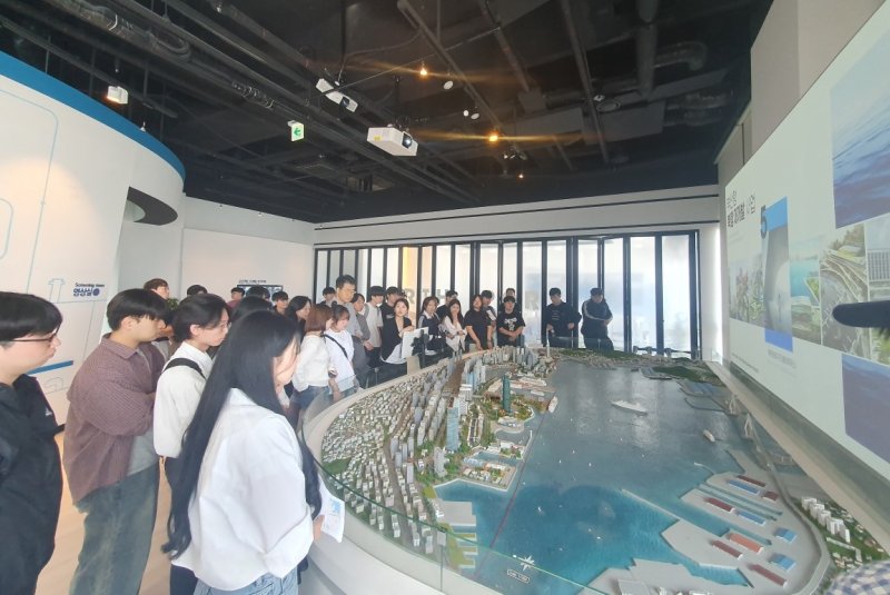[창원=뉴시스]28일 사설 바카라의 '도내 대학생 대상 항만프로그램 체험 행사'에 참여한 경남대학교 무역물류학과 재학생들이 북항재개발 홍보관에서 설명을 듣고 있다.(사진=경남도 제공)2025.05.28. photo@newsis.com