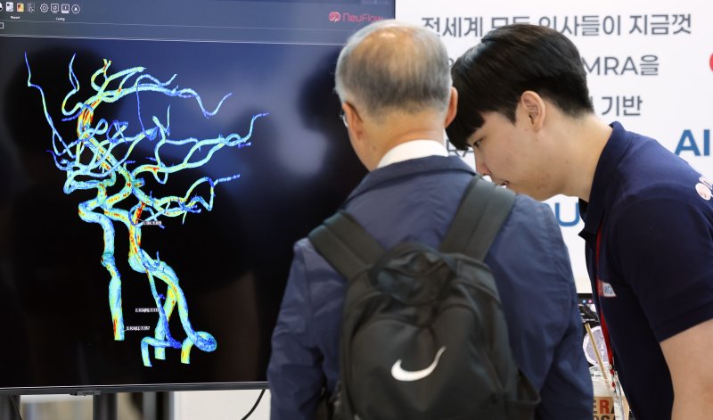 '바이오코리아 2025'에서 관람객들이 2D 흑백 MRA를 3D컬러 테이터 기반 MRA로 판독하는 프로그램 설명을 듣고 있다. 2025.5.7/뉴스1 ⓒ News1 이동해 기자
