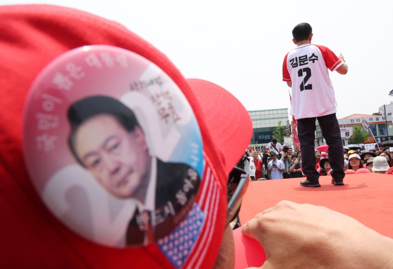 [김해=뉴시스] 고승민 기자 = 사설 바카라 국민의힘 대선 후보가 28일 경남 김해수로왕릉 공원에서 유세를 하고 있다. 어느 윤석열 전 대통령 지지자가 이를 가까이서 지켜보고 있다. 2025.05.28. kkssmm99@newsis.com