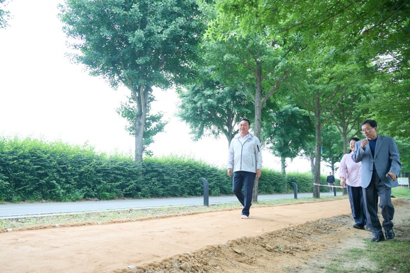 [여주=뉴시스]흙향기 맨발길 조성 현장을 걷고 있는 이충우 시장(사진=여주시 제공) 2025.06.05.photo@newsis.com