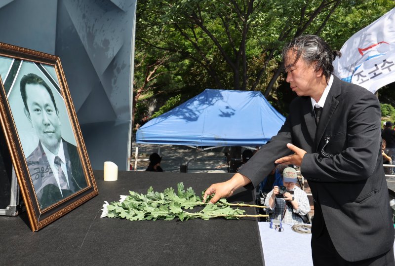 6일 오후 서울 용산구 서울역 앞 한강대로에서 열린 태안화력 김충현 비정규직 노동자 사망사고 대책위원회 주최 추모문화제에서 유족이 고인의 영정에 헌화하고 있다. 2025.6.6/뉴스1 ⓒ News1 장수영 기자