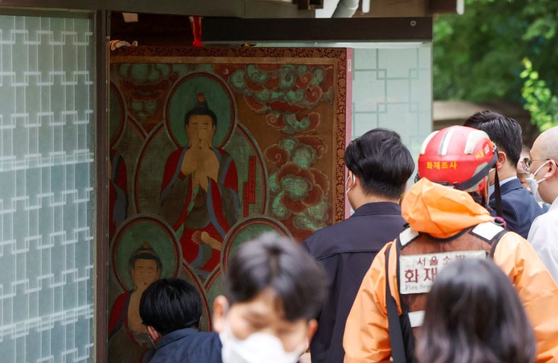 [서울=뉴시스] 김명년 기자 = 10일 오전 서울 종로구 조계사 옆 한국불교역사문화기념관 국제회의장에서 화재가 발생해 관계자들이 문화재를 옮기고 있다. 2025.06.09. kmn@newsis.com
