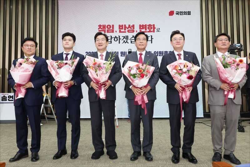 송언석 국민의힘 신임 원내대표 등이 16일 오후 서울 여의도 국회에서 열린 2025 국민의힘 원내대표 선출 의원총회에서 꽃다발을 들고 있다. (공동취재) 2025.6.16/뉴스1 ⓒ News1 이재명 기자