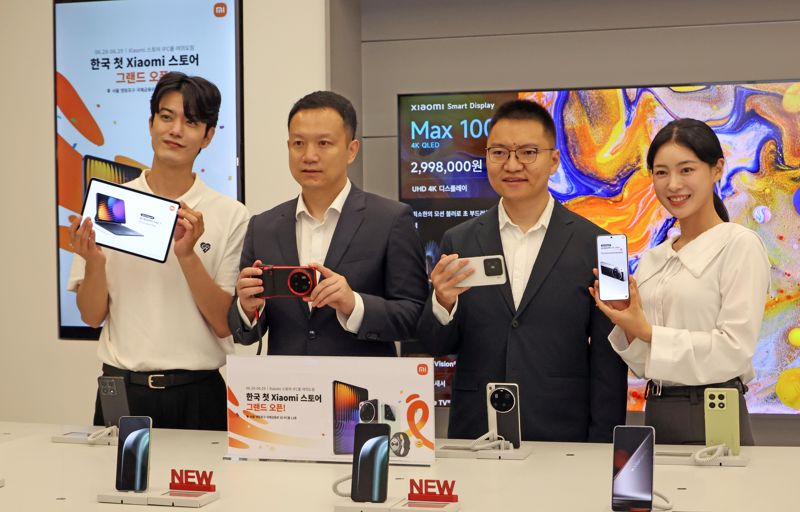 조니 우 샤오미코리아 사장(왼쪽 두 번째)과 앤드류 리 샤오미 동아시아 총괄(쪽 세번째)이 25일 서울 영등포구 여의도 샤오미 스토어 서울 IFC몰 여의도점에서 열린 첫 공식 오프라인 매장 오픈 기념행사에서 모델들과 함께 제품을 소개하고 있다. 사진=박범준 기자.