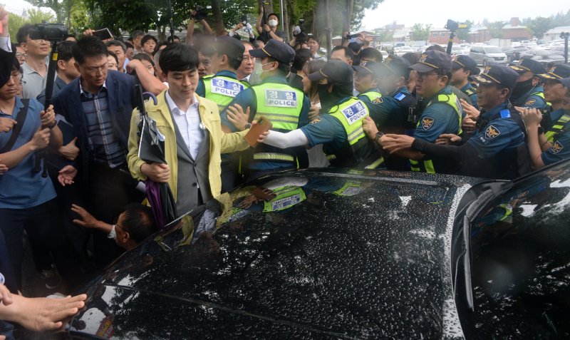 [완주=뉴시스] 김얼 기자 = 경찰관들이 25일 전북 완주군 완주군청을 빠져나가려는 김관영 전북특별자치도지사의 차량을 막아선 완주군민들 사이에서 차량 통제를 하고 있다. 2025.06.25. pmkeul@newsis.com