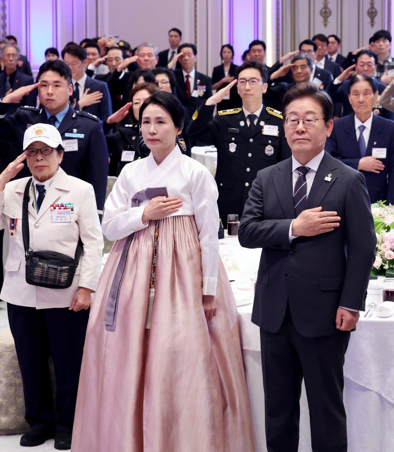 [서울=뉴시스] 최진석 기자 = 이재명 대통령과 부인 김혜경 여사가 27일 청와대 영빈관에서 열린 '호국보훈의 달, 대통령의 초대' 행사에서 국기에 경례하고 있다. (대통령실통신사진기자단) 2025.06.27. myjs@newsis.com