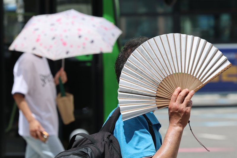 [서울=뉴시스] 권창회 기자 = 서울지역에 이틀째 폭염주의보가 지속중인 1일 서울 종로구 광화문광장 인근에서 시민들이 부채와 양산으로 햇빛을 가리고 있다. 2025.07.01. kch0523@newsis.com