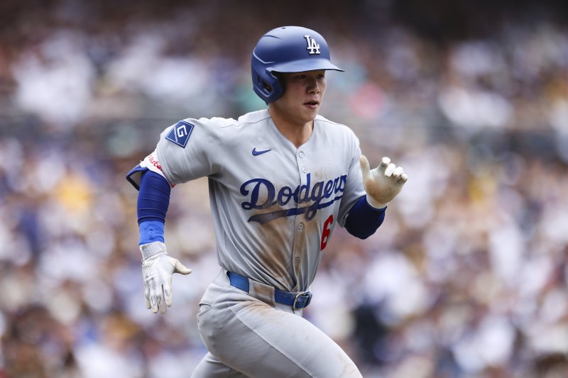 Los Angeles Dodgers' Hyeseong Kim runs to first base as he grounds out to San Diego Padres' Jake Cronenworth in the fifth inning of a baseball game Wednesday, June 11, 2025, in San Diego. (AP Photo/Derrick Tuskan)