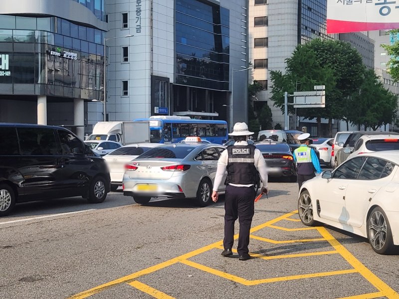 뙤약볕 속 출근길 교통단속 중인 교통경찰 (출처=연합뉴스)
