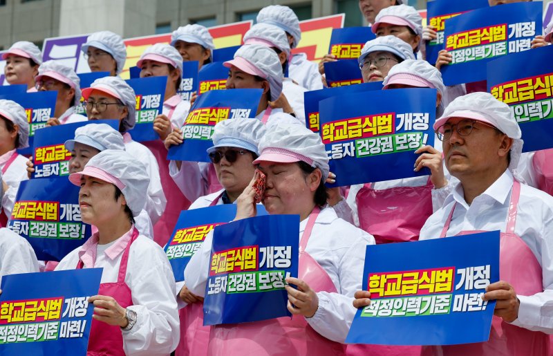 작업복을 입은 학교바카라사이트 홈런조리사들이 2일 서울 여의도 국회 본청 계단에서 열린 민주노총 서비스연맹 전국학교비정규직노동조합 '학교급식 노동자 건강과 안전 확보를 위한 학교급식법 개정안 발의 기자회견'에서 손팻말을 들고 있다. 2025.7.2/뉴스1 ⓒ News1 안은나 기자